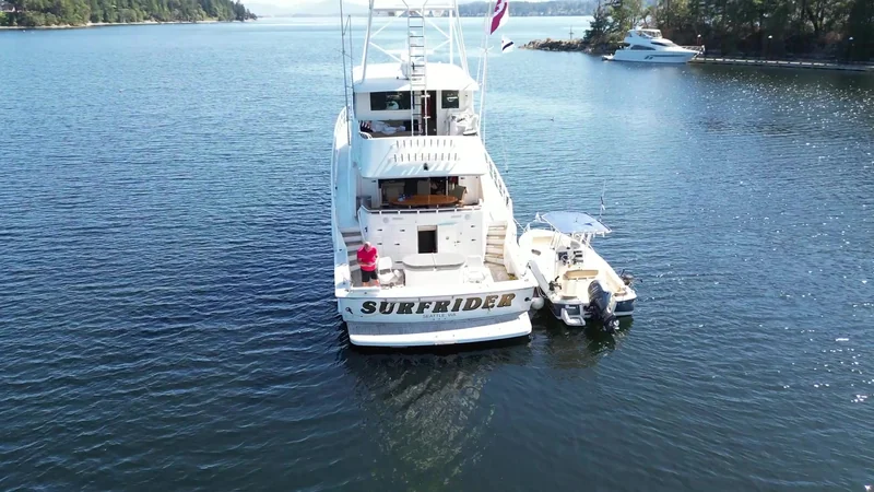 Aerial stern view of Surfrider with a center-console boat alongside near Ovens Island.