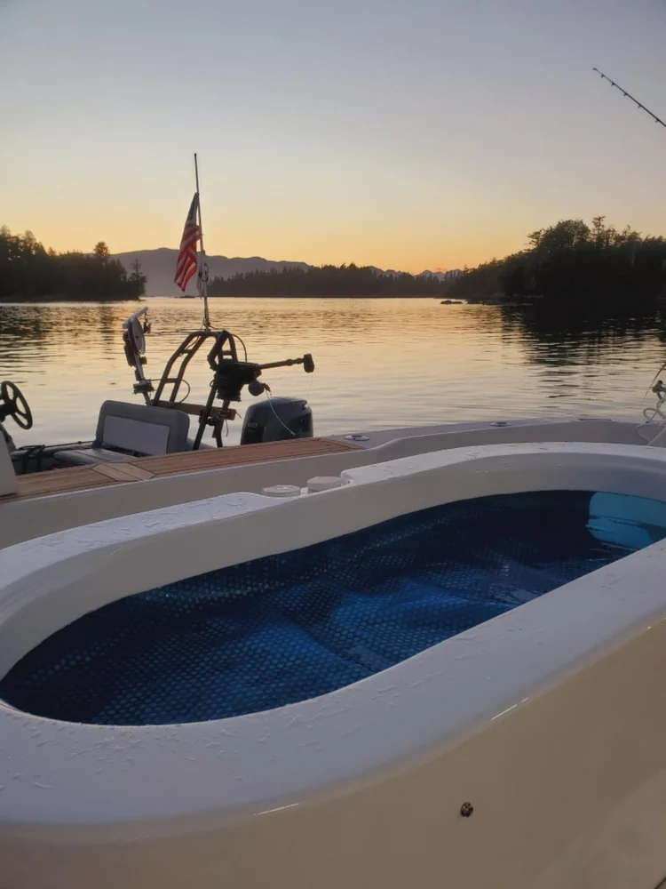 Surfrider's cockpit hot tub and water beyond at sunset.