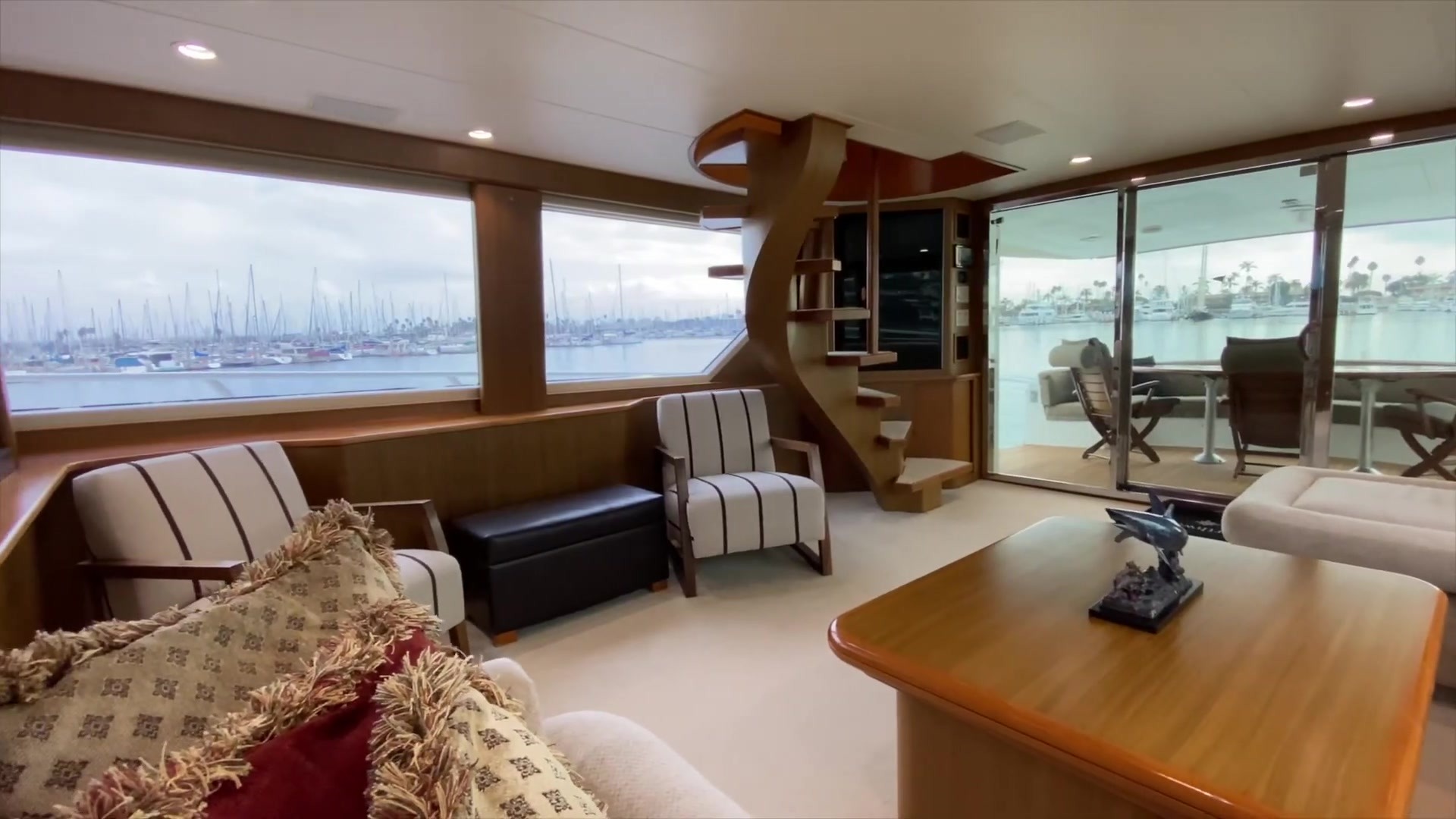 Salon view toward the aft-deck doors and interior stairs