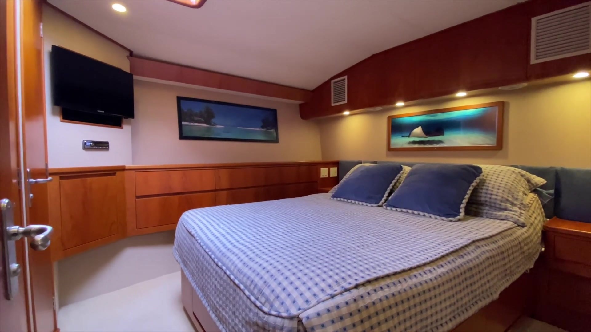 Stateroom with a bed, cabinetry and a doorway