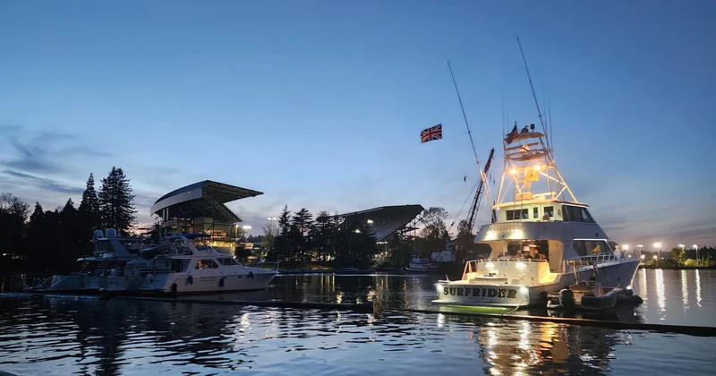Surfrider illuminated at dusk beside Husky Stadium.