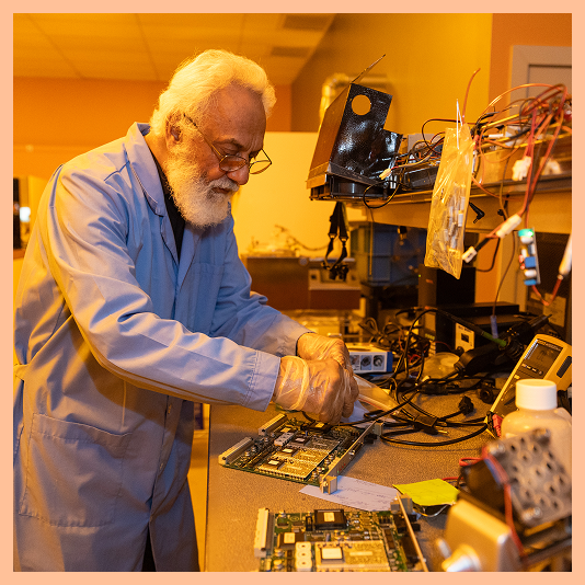 A GCE engineer refurbishing a control board at the bench