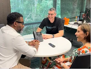 Healthmap team members meeting around a table.