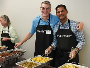 Healthmap team members serving food at a community event.