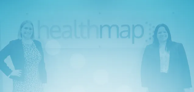 Healthmap team members beside the company office sign.
