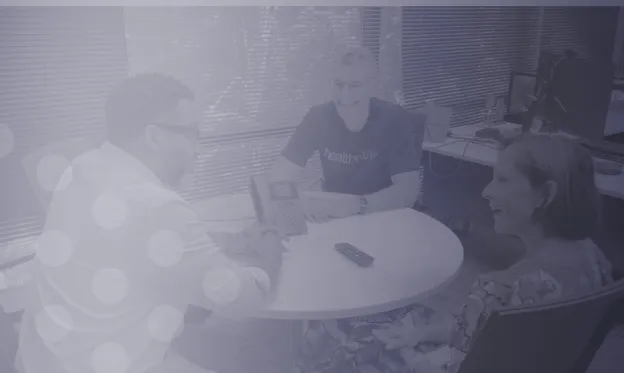 Healthmap team members collaborating around a table.