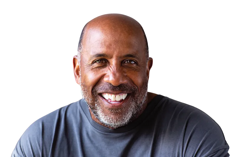 Smiling middle-aged man with a bald head and salt-and-pepper beard wearing a dark gray shirt.