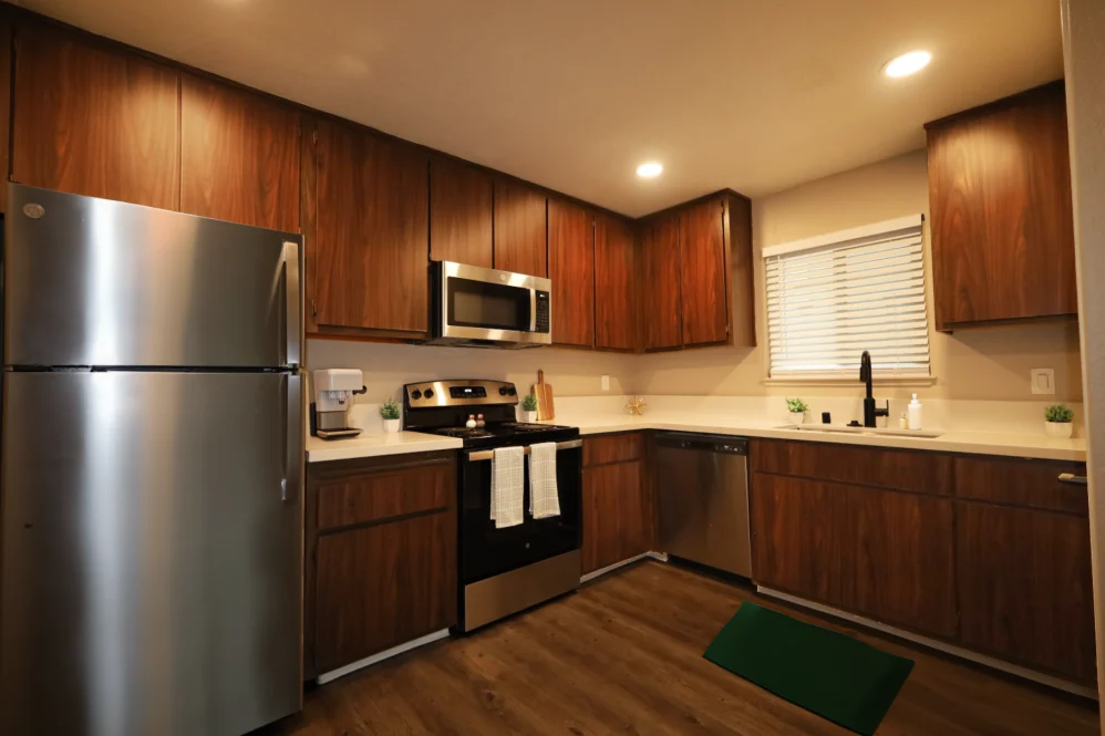 Kitchen area with wood-look material cabinets 