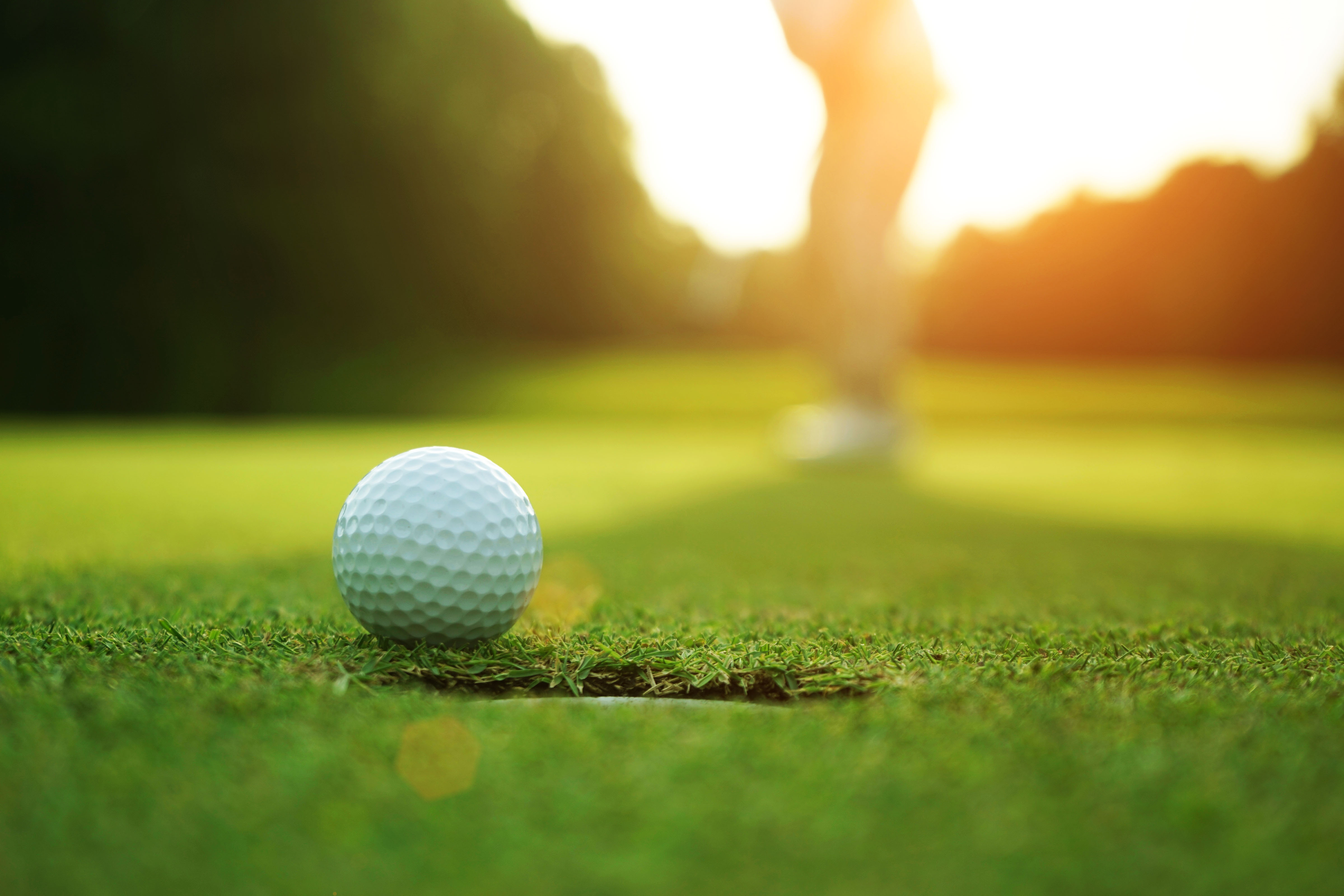 Golf ball on grass stock image