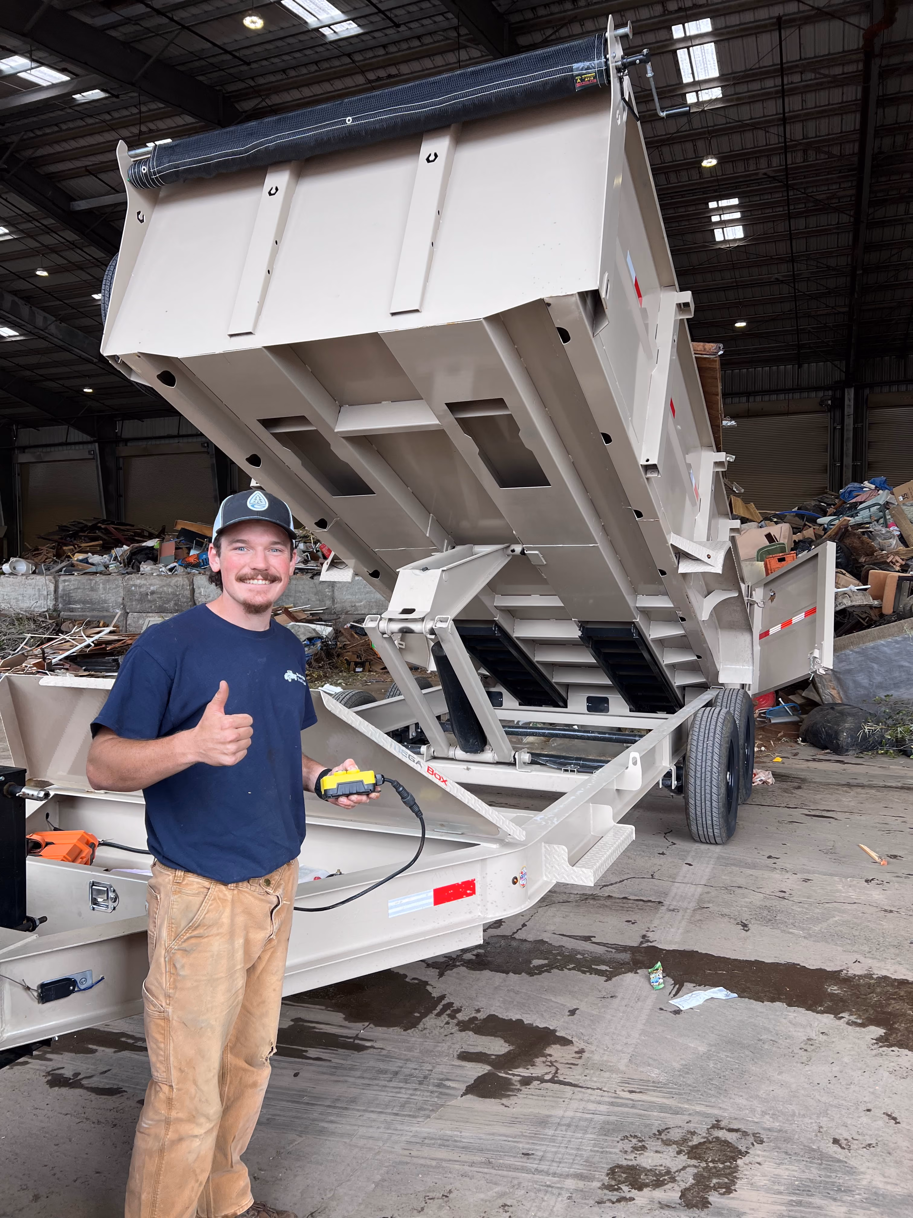 Aidan tipping the dump trailer at a transfer station, where the sorted remainder of a load is dropped off