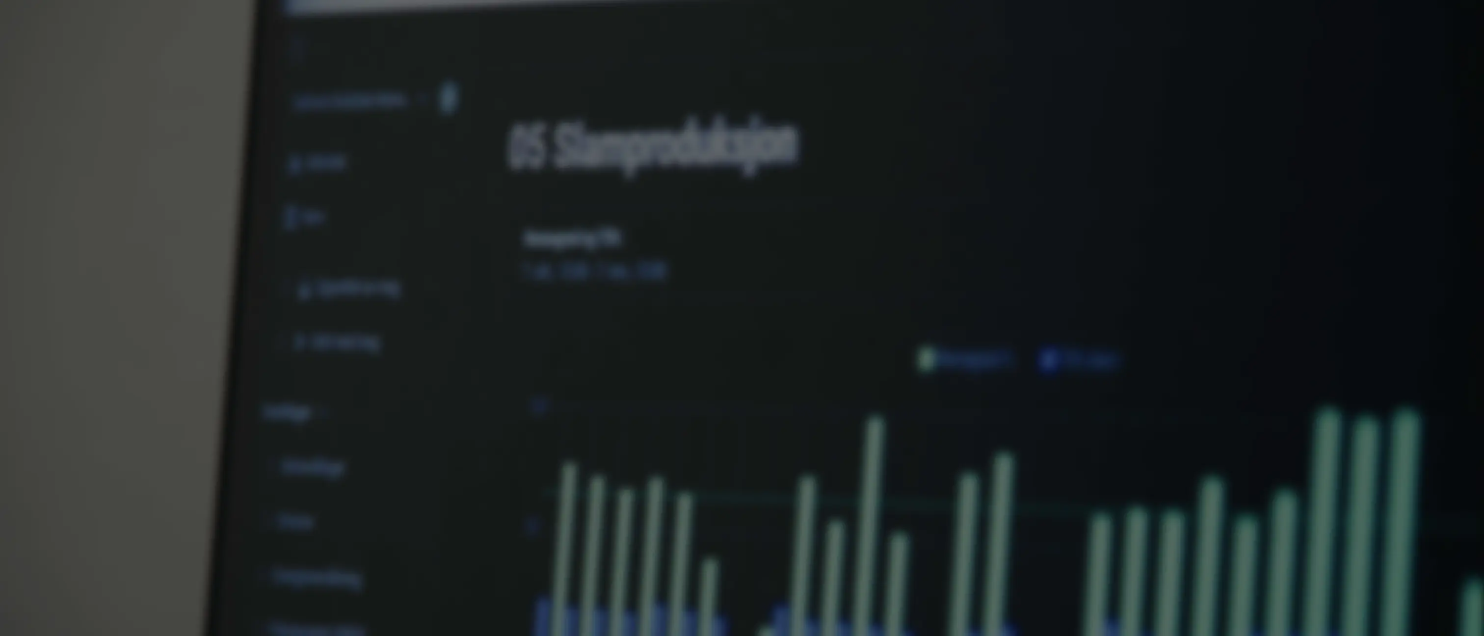 Blurred image of a computer screen displaying a data chart with vertical bars and the heading 'OS Stampsediskation'.