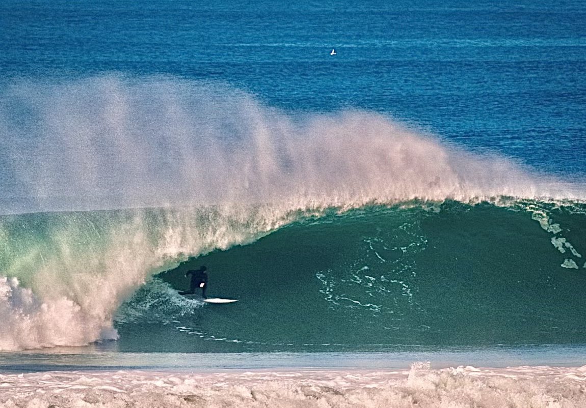 Surfing a wave on the Northern California coast