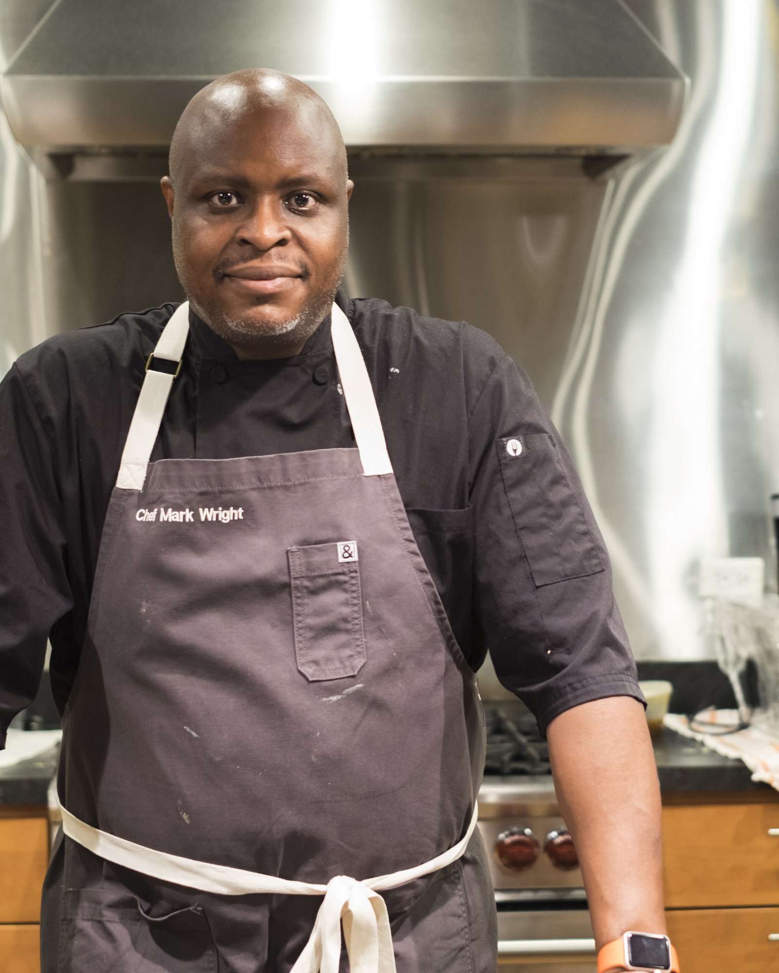 Chef Mark Wright in the kitchen, wearing a Black & Wright apron