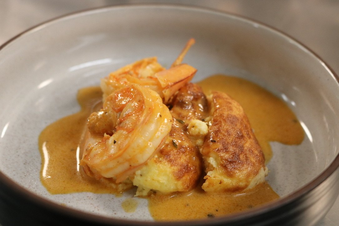Shrimp in gravy over souffléd cornbread