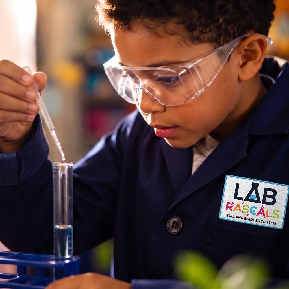 A young student carefully observing a science experiment