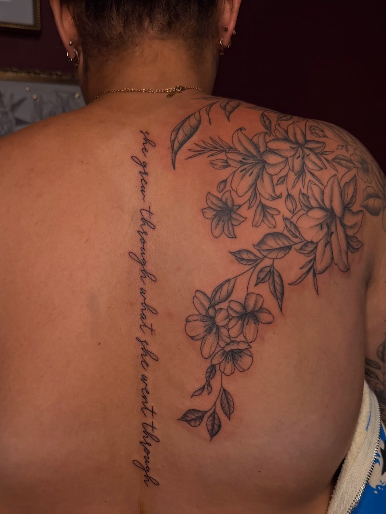 Fine line floral back piece with script lettering