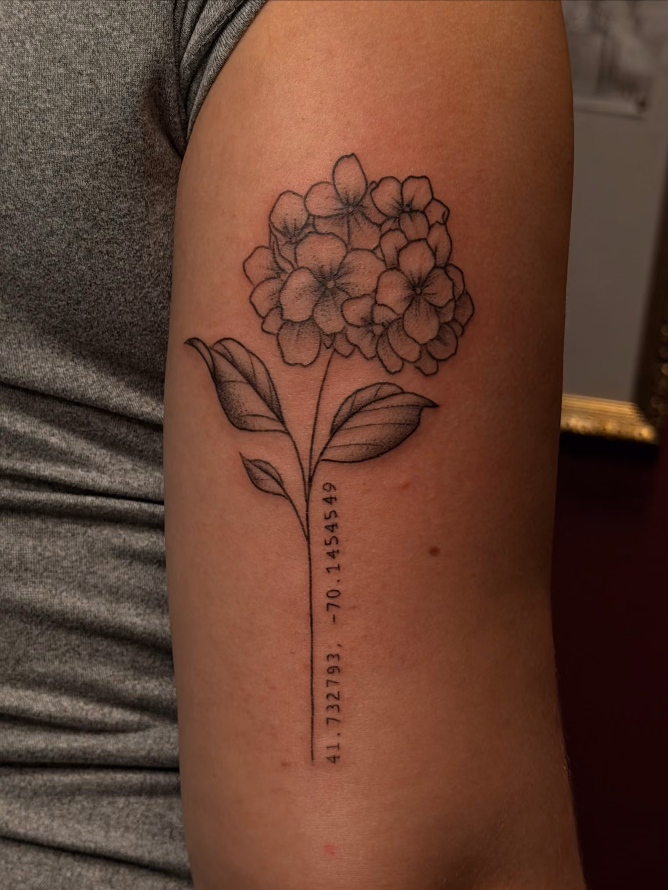 Custom fine line flower stem tattoo designed with the client