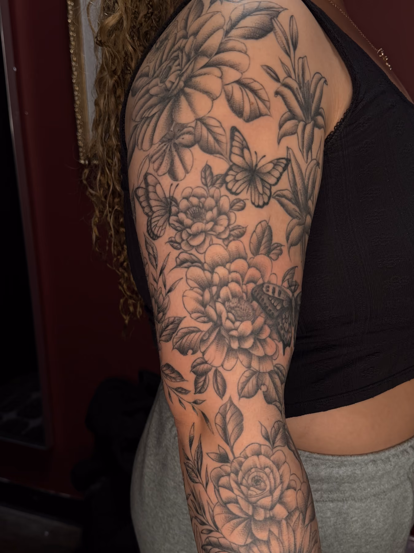 Black and grey floral sleeve tattoo