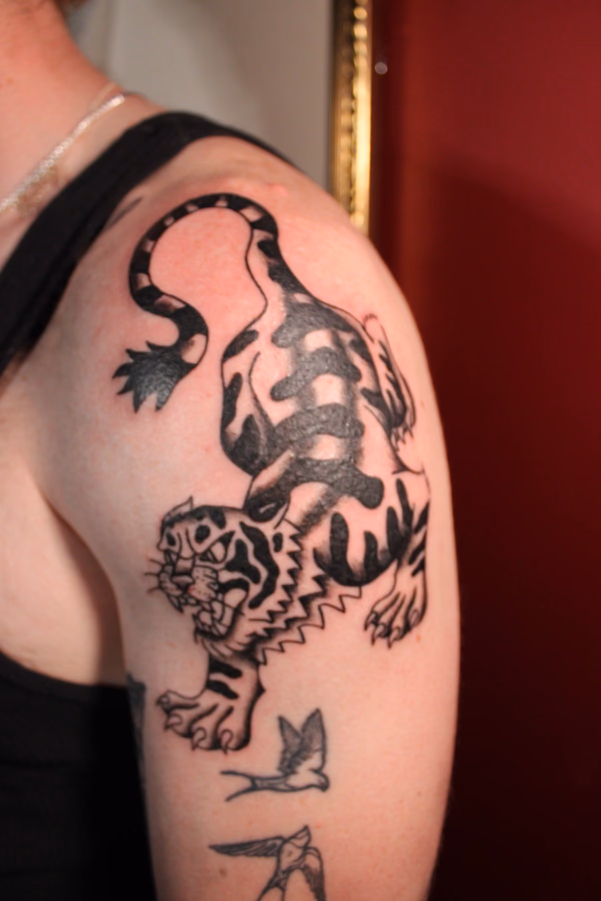 Traditional tiger and dragon arm tattoo