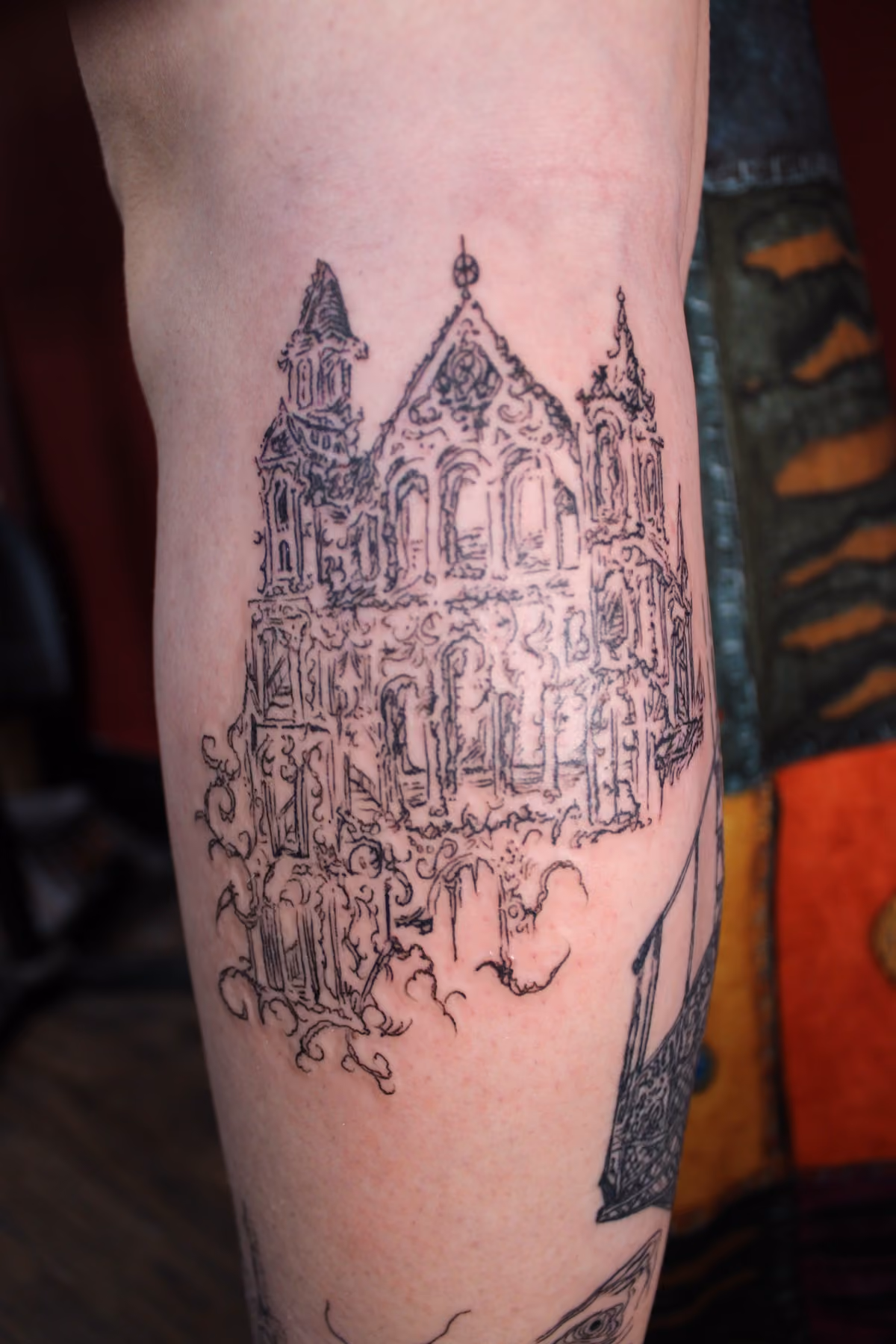 Fine line castle forearm tattoo