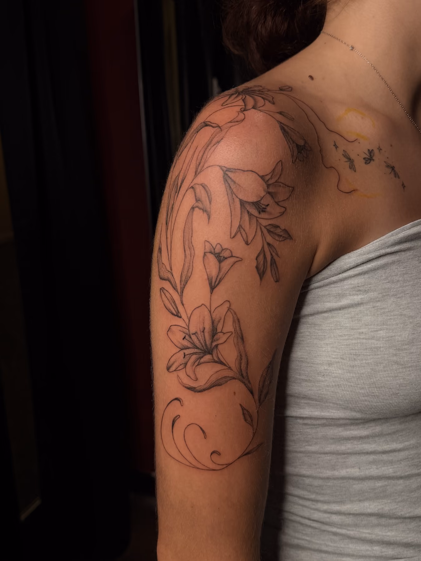Fine line floral arm tattoo by Thorn & Dagger Ink