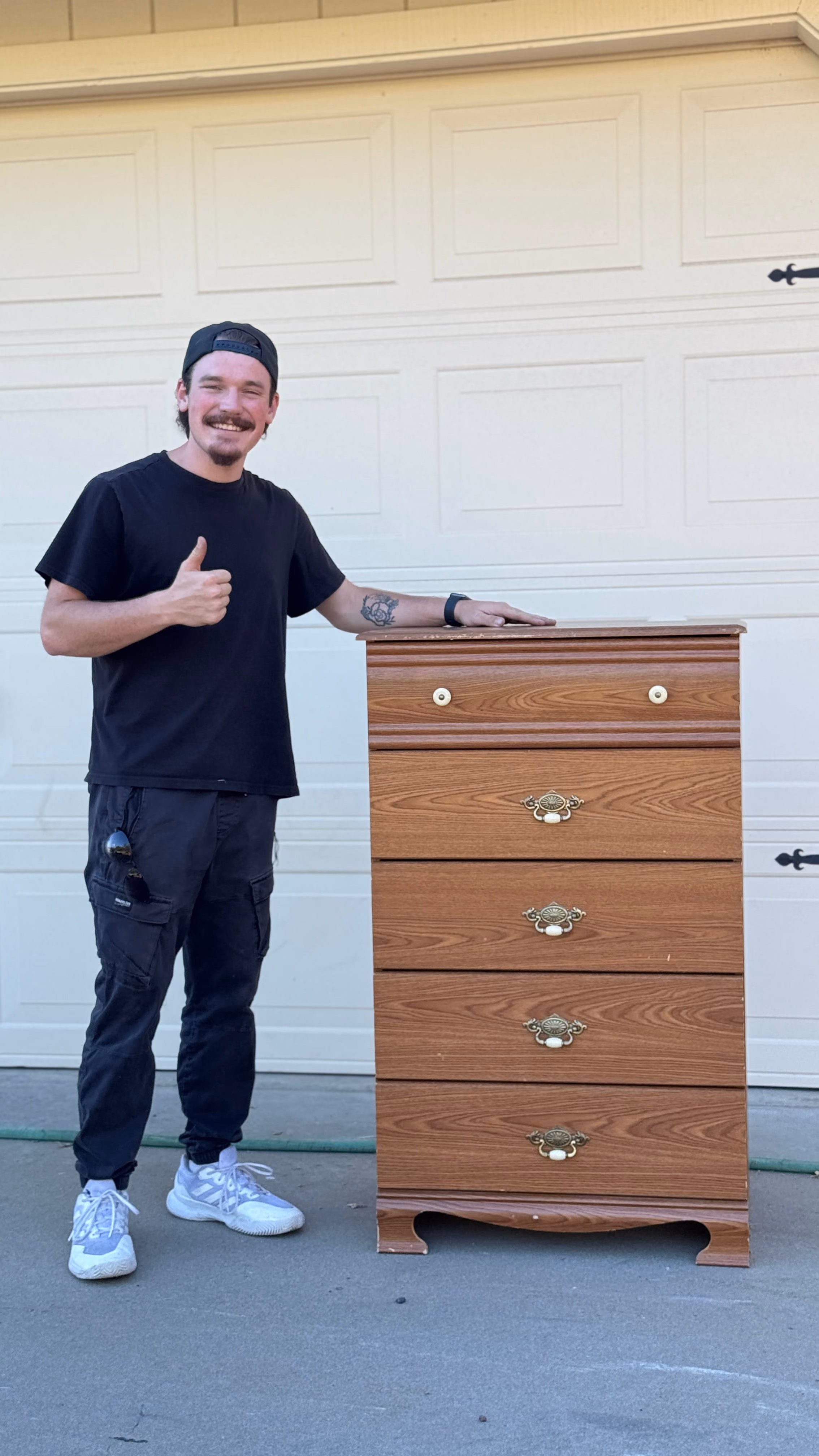 Aidan with a wooden chest of drawers collected from a garage