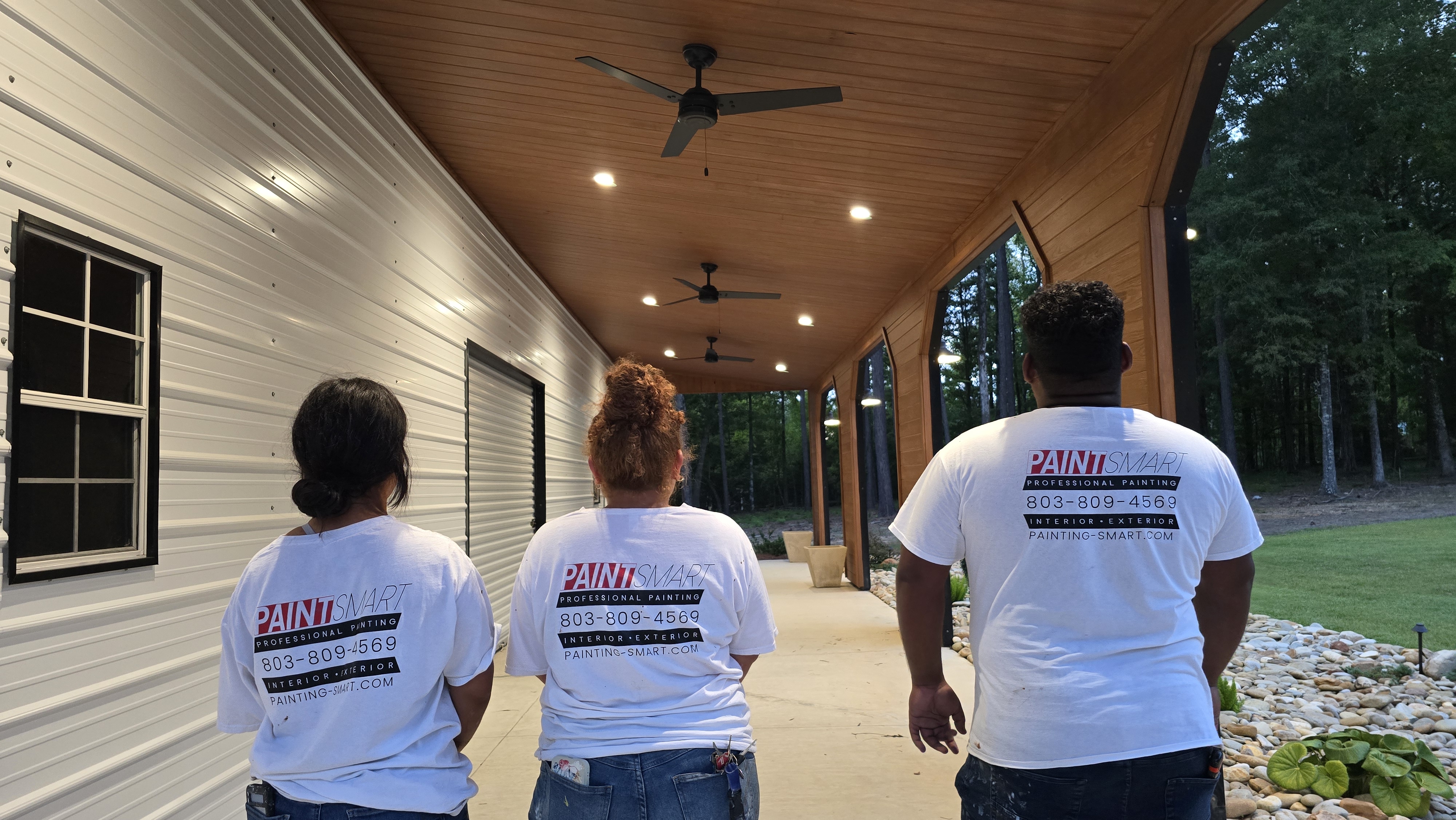 PaintSmart painting crew in company shirts on a finished covered porch