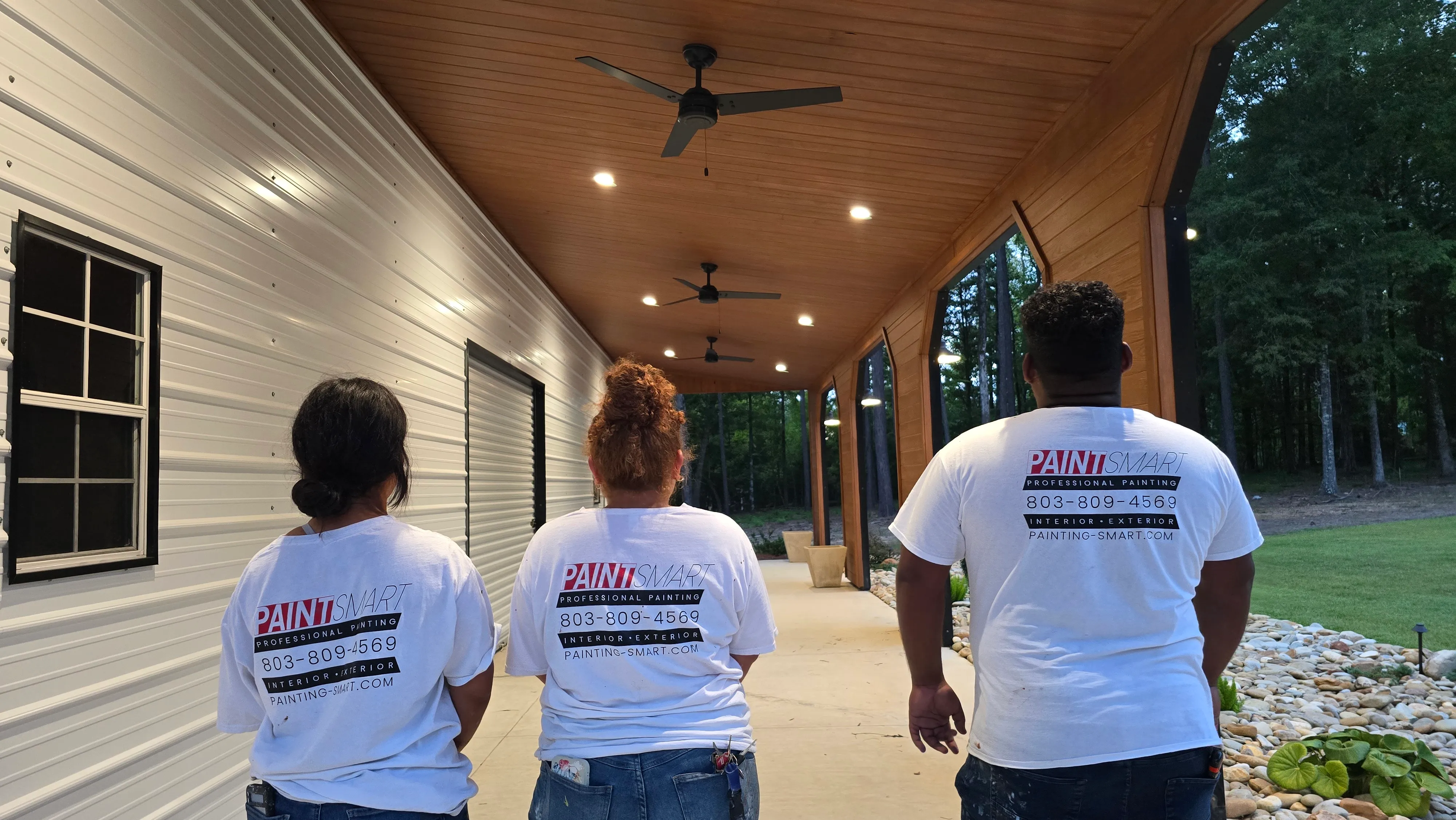 PaintSmart painting crew in company shirts on a finished covered porch