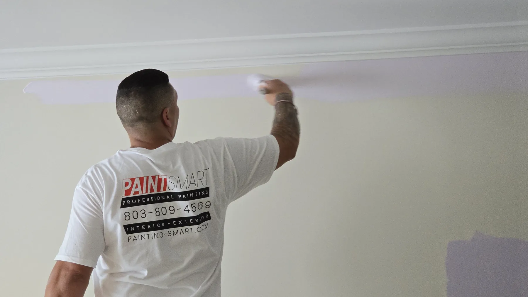 PaintSmart painter brushing crown molding and ceiling edge during an interior painting job in Irmo, SC