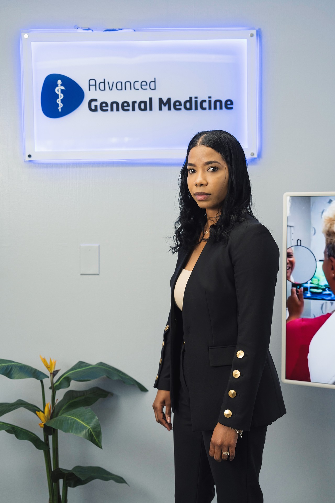 Yolanny Ramirez, MSN, FNP-C, Family Nurse Practitioner, standing in front of the Advanced General Medicine sign in Elizabeth, NJ