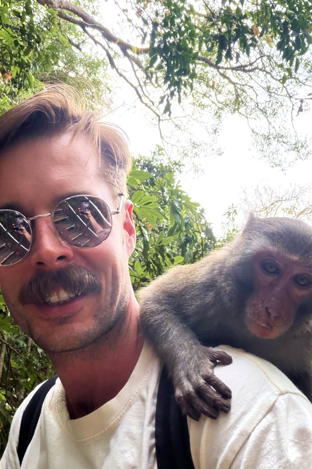 Photo of Alexander with a macaques on his back