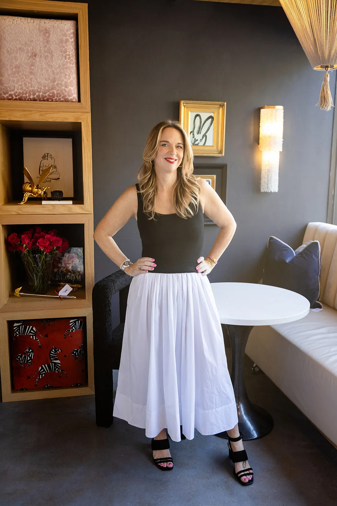 Christine Lord relaxed in a blush upholstered armchair in a softly styled living space
