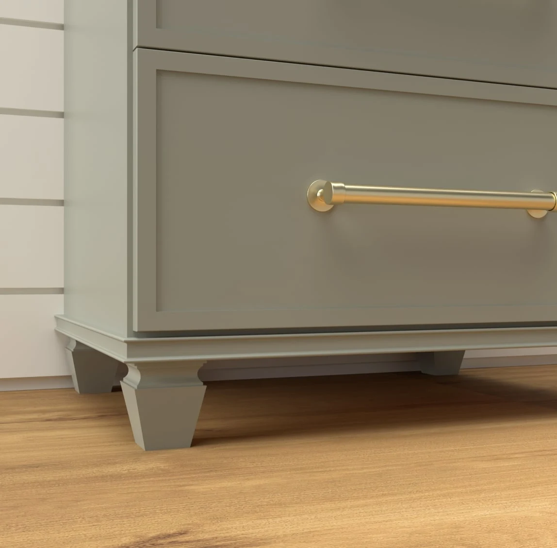 Close view of a sage green vanity drawer with a brass pull