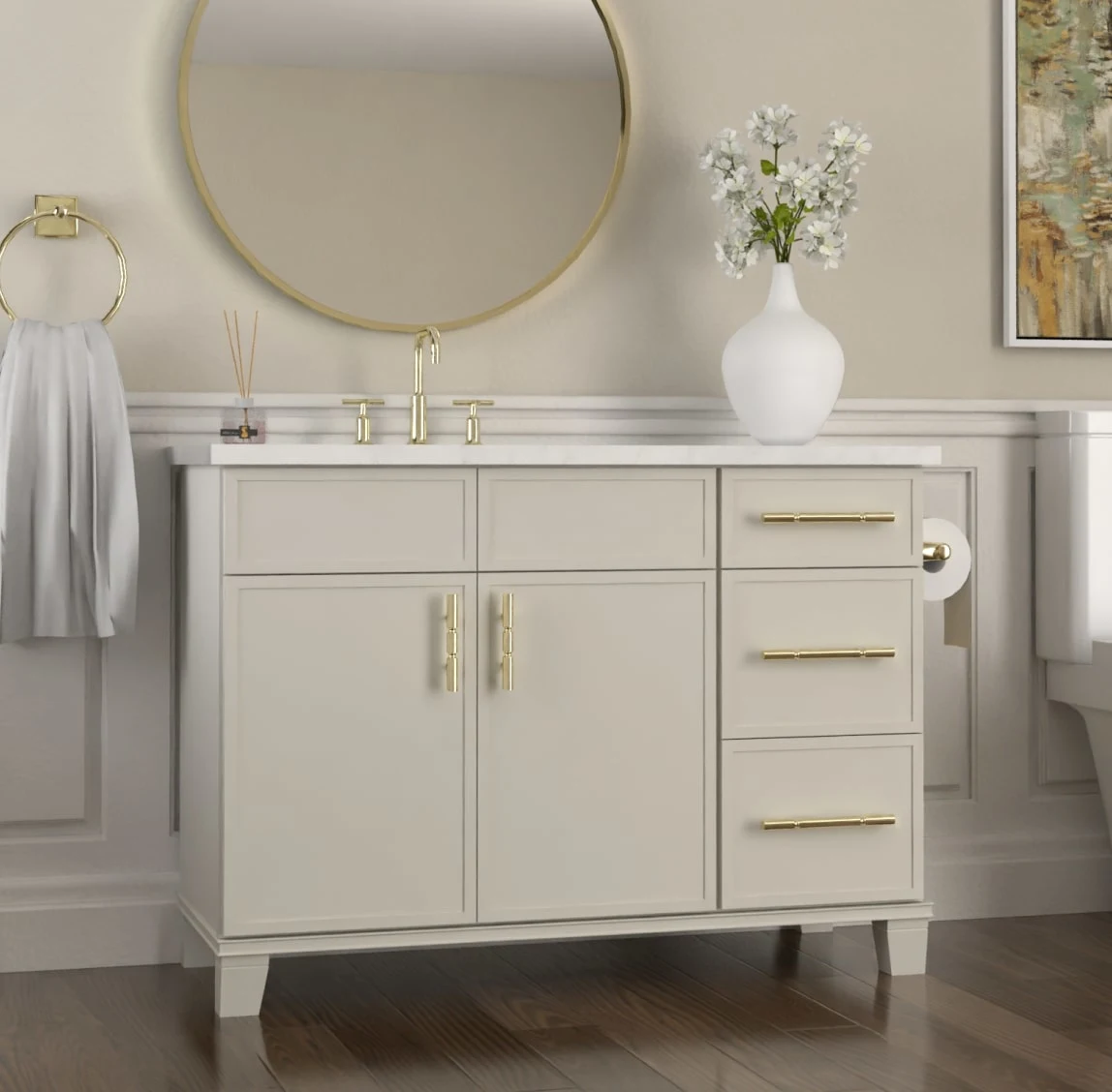 White bath vanity with brass pulls beneath a round brass mirror