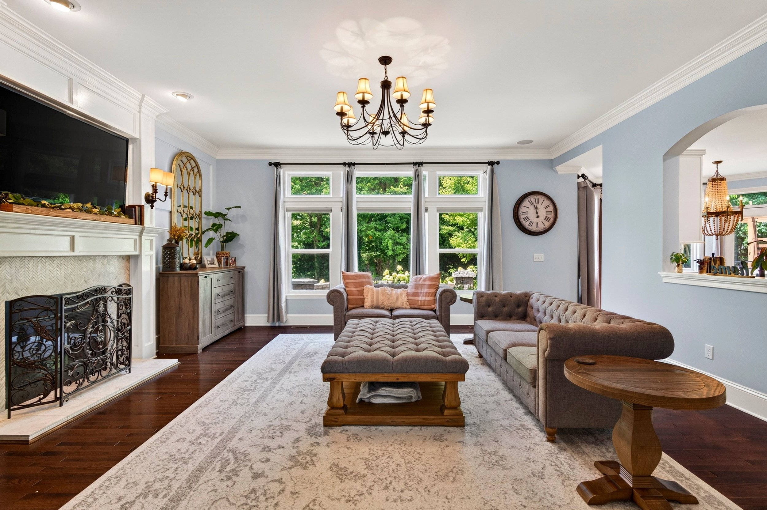 Living room with fireplace and tall windows