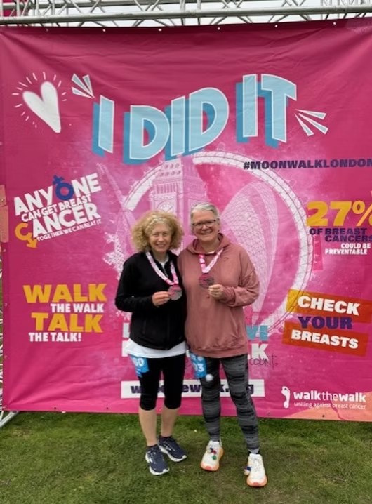 Two Rudman Coaching clients with their medals after the MoonWalk London night-time walking marathon