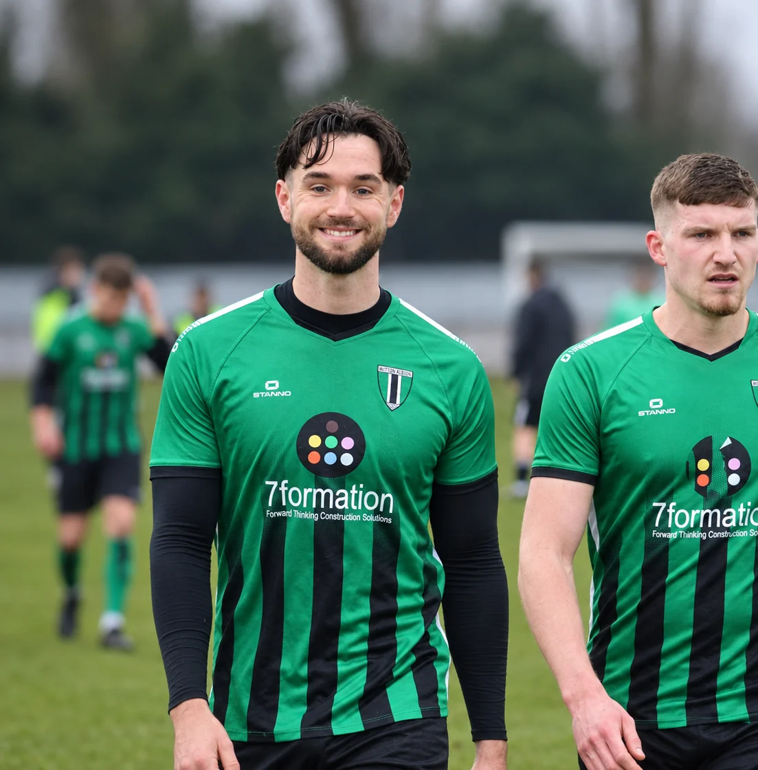 Nathan Rudman smiling as he walks off a football pitch after a match