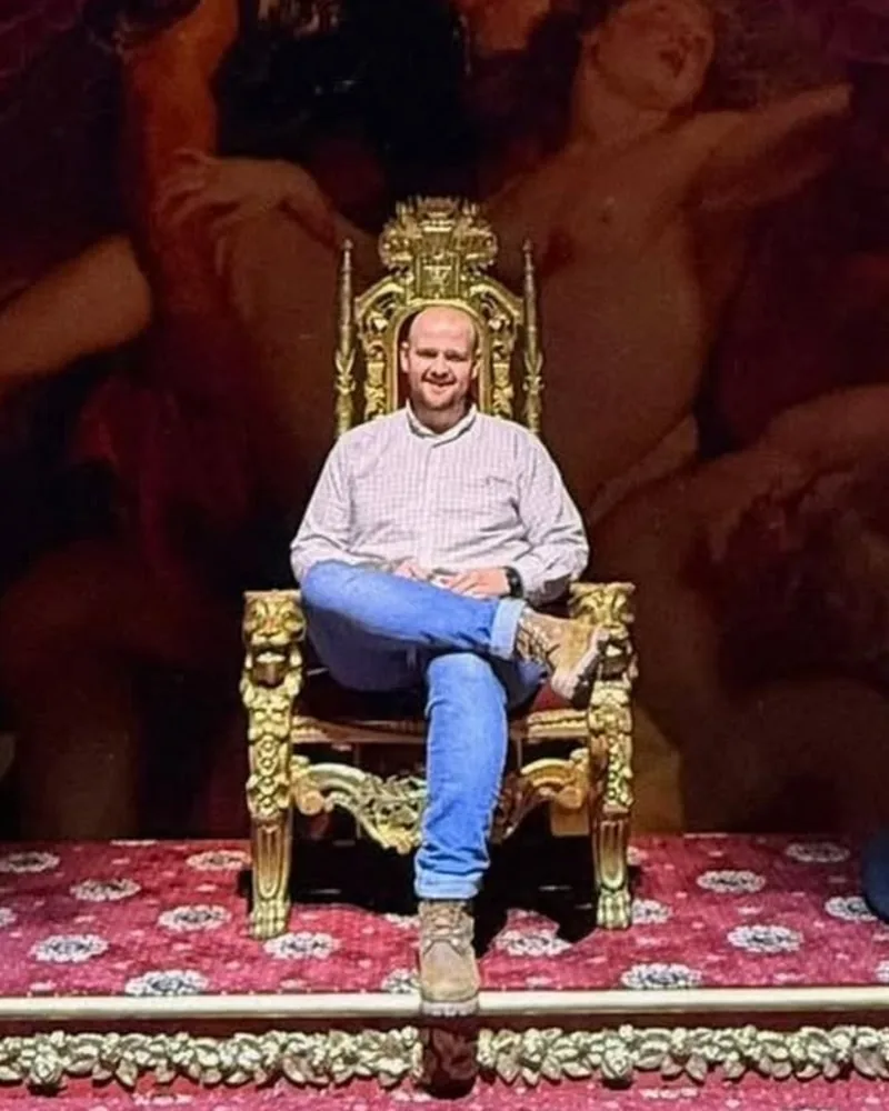 Ryan after losing nearly 50kg, sitting on a gilded throne in a shirt and jeans