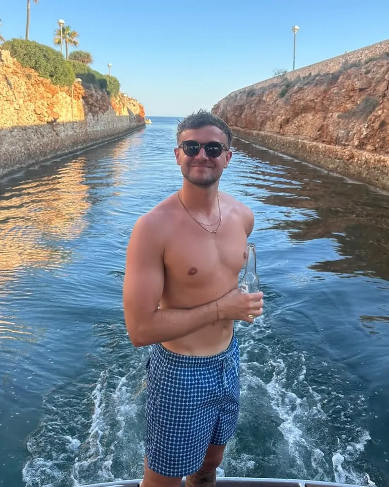 Zak at the start, around 80kg, standing on the back of a boat