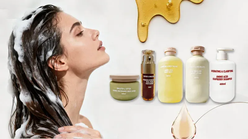 Personal care products: amino acid shampoo, body wash, body lotion, hair essence and body scrub, beside a woman rinsing shampoo from her hair