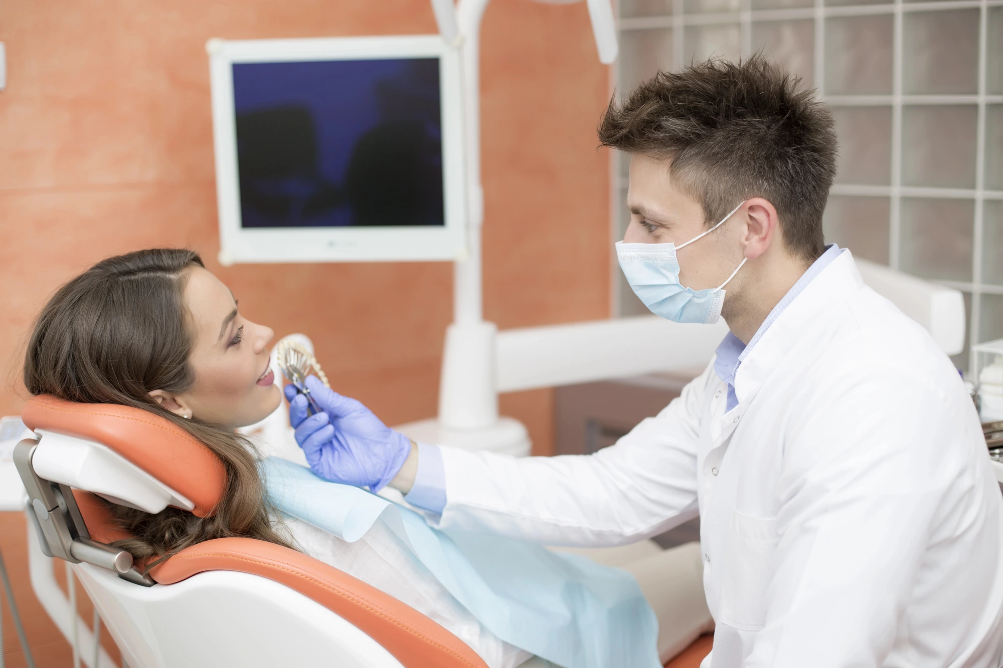 dentist and patient talking about dental implants in Lenoir, NC
