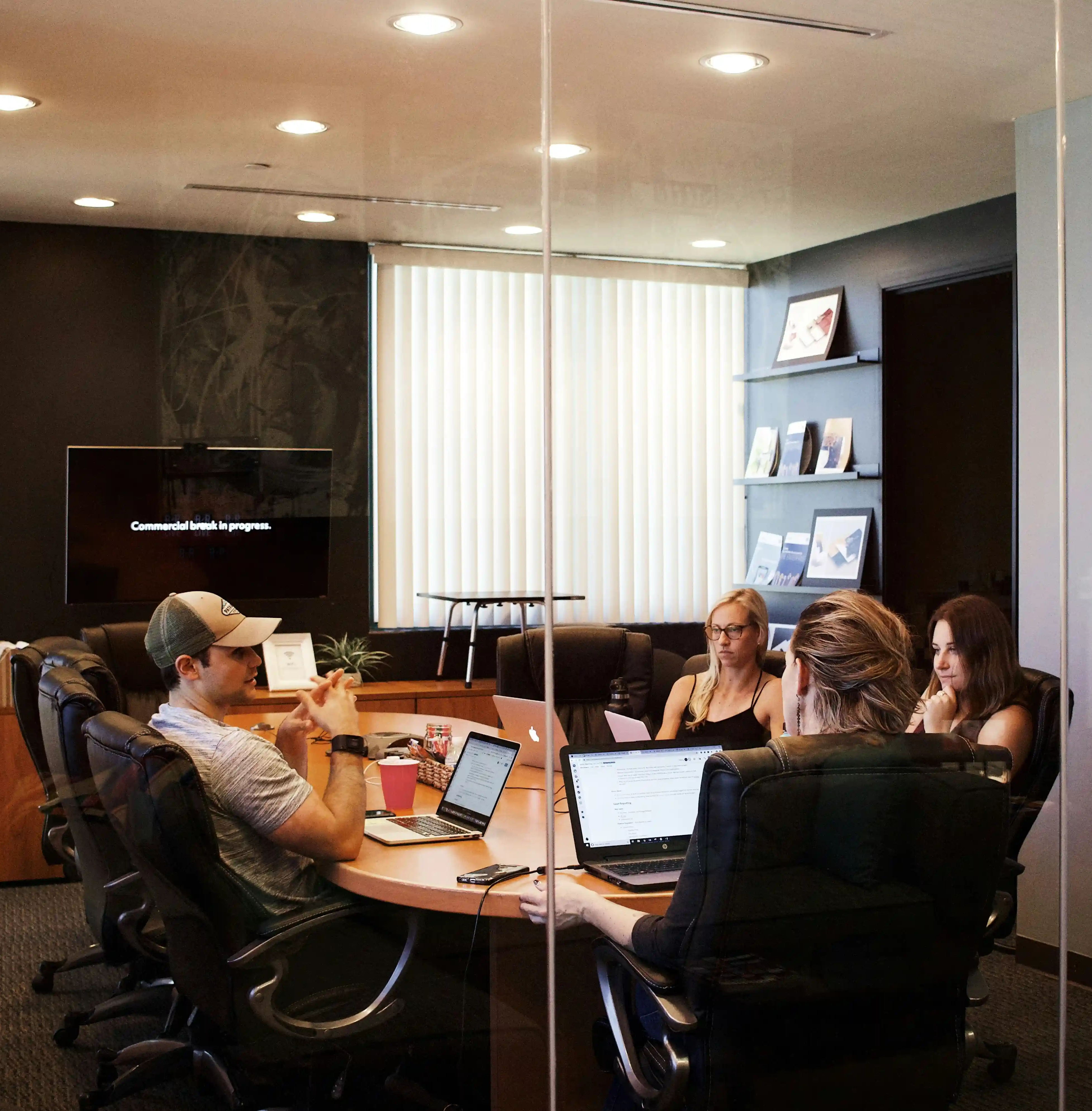 A small team working through a discussion around a boardroom table