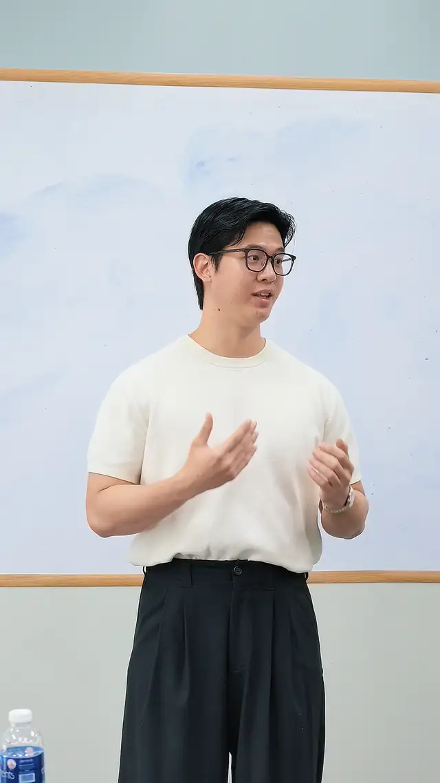Course participant presenting at the whiteboard during public speaking training in Singapore