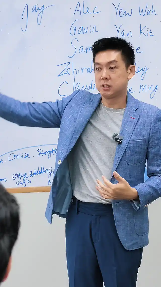 Iwan Yang coaching at the whiteboard during a public speaking course in Singapore