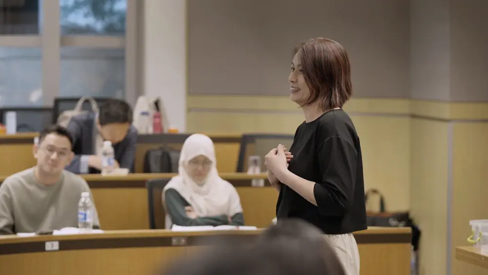 Woman showing a bar chart on a tablet as she walks a client through a proposal