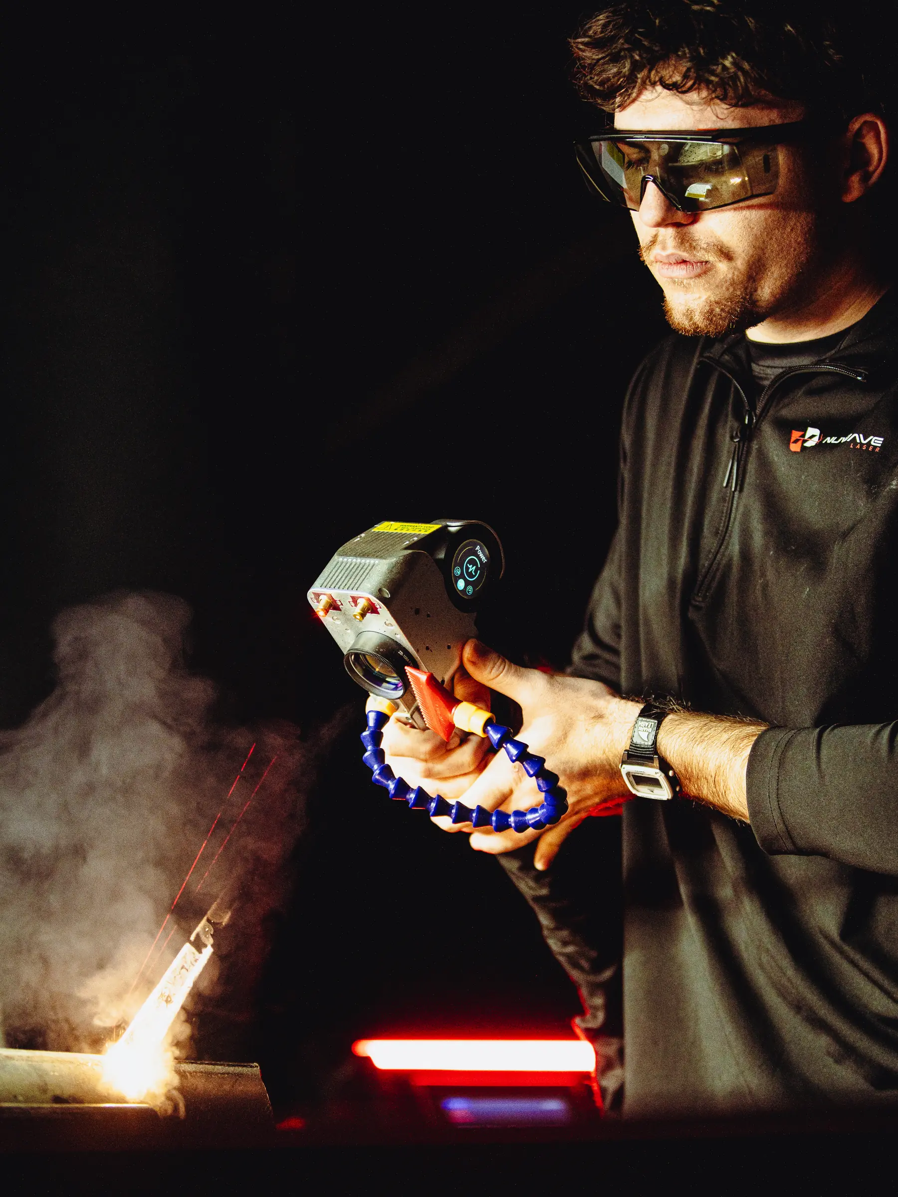 Nuwave technician using a handheld laser cleaner