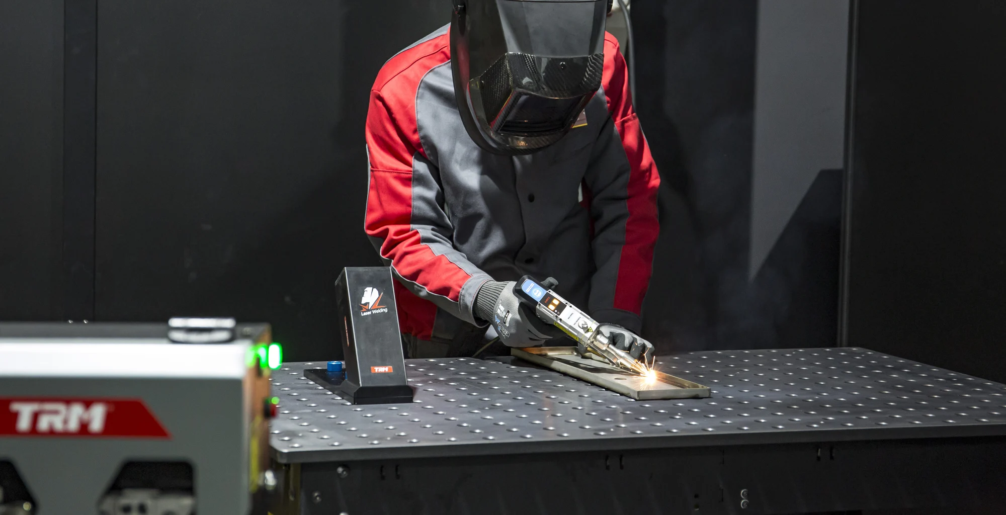 Operator using a TRM handheld laser welding torch