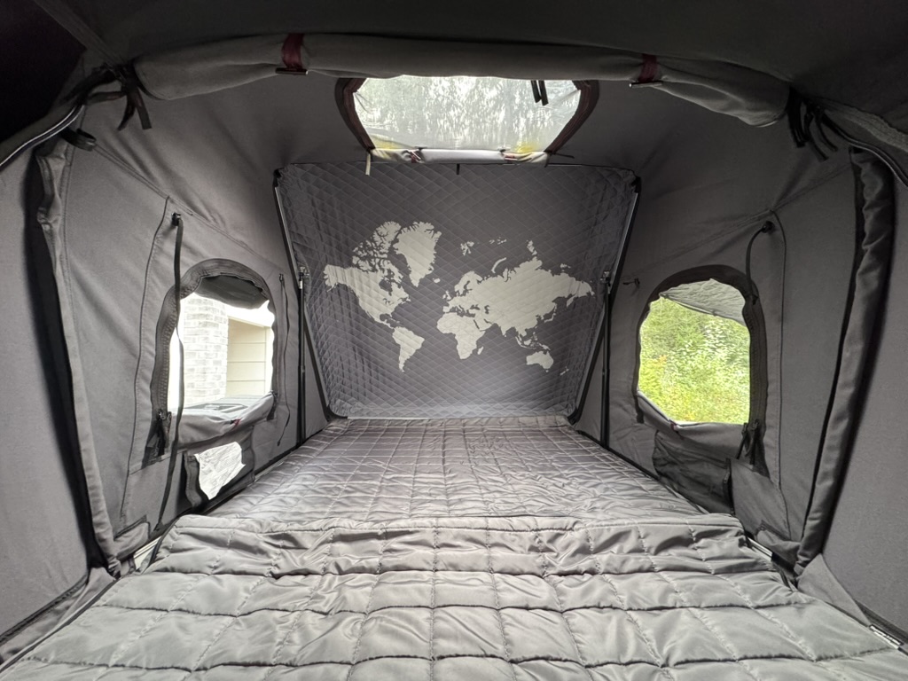 Interior of iKamper Skycamp rooftop tent with bedding ready for overnight camping
