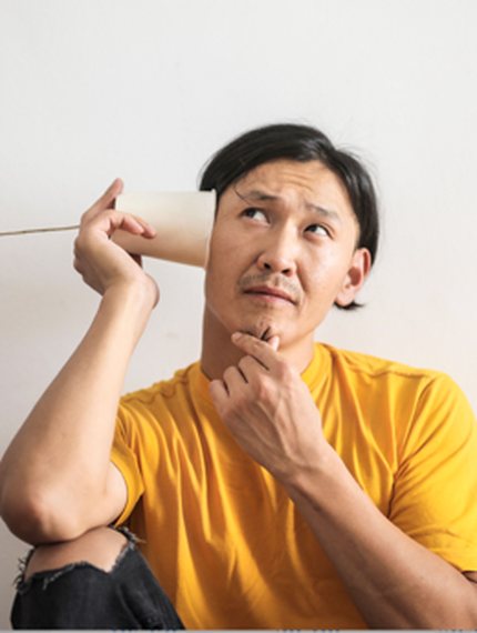 Une personne assise, repliée sur elle-même, à côté d’une autre debout