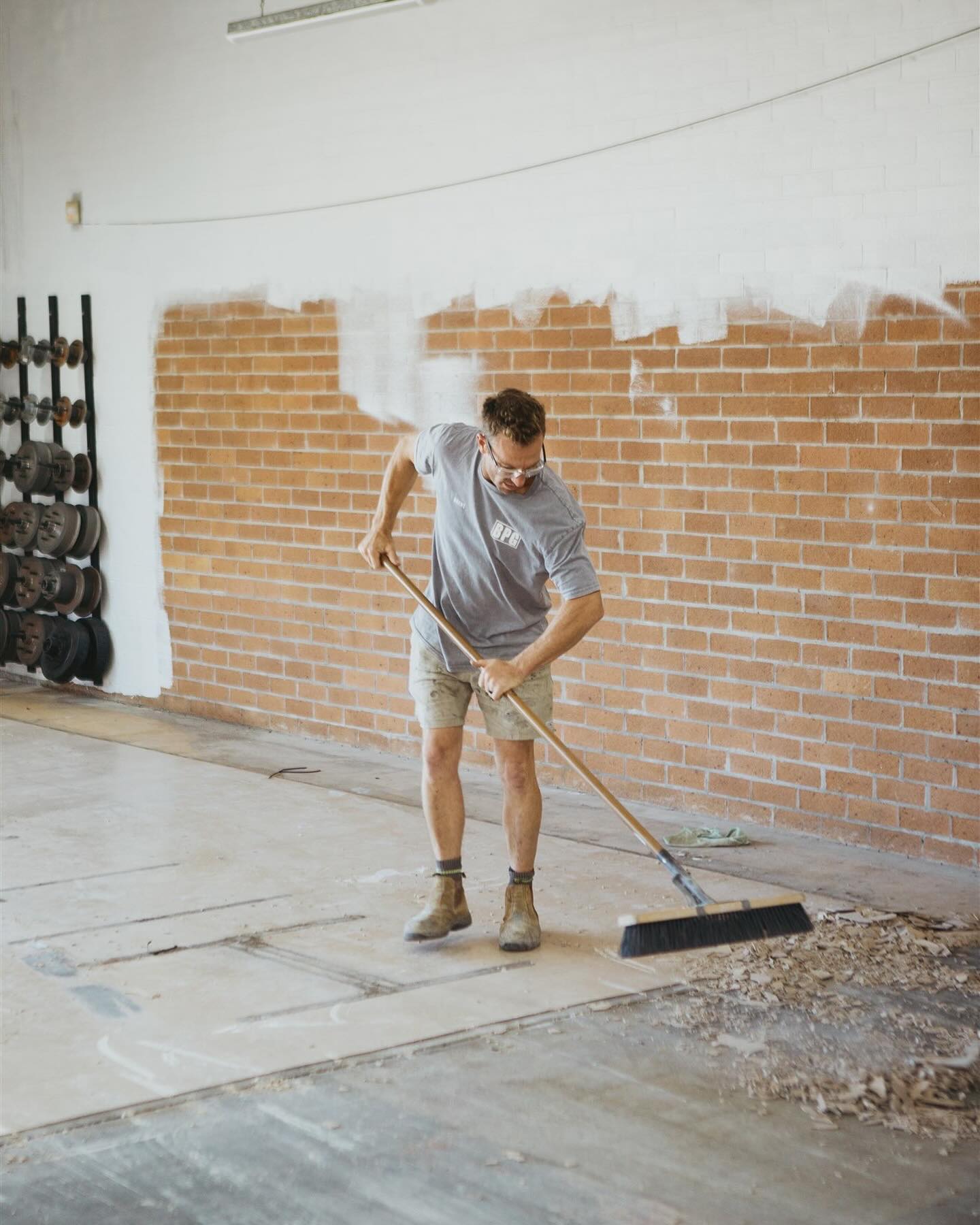 Blast Prep Grind operator sweeping down a stripped commercial slab before handover to the next trade